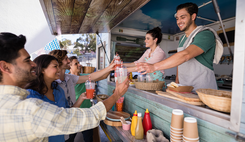 Food truck crew working together during service