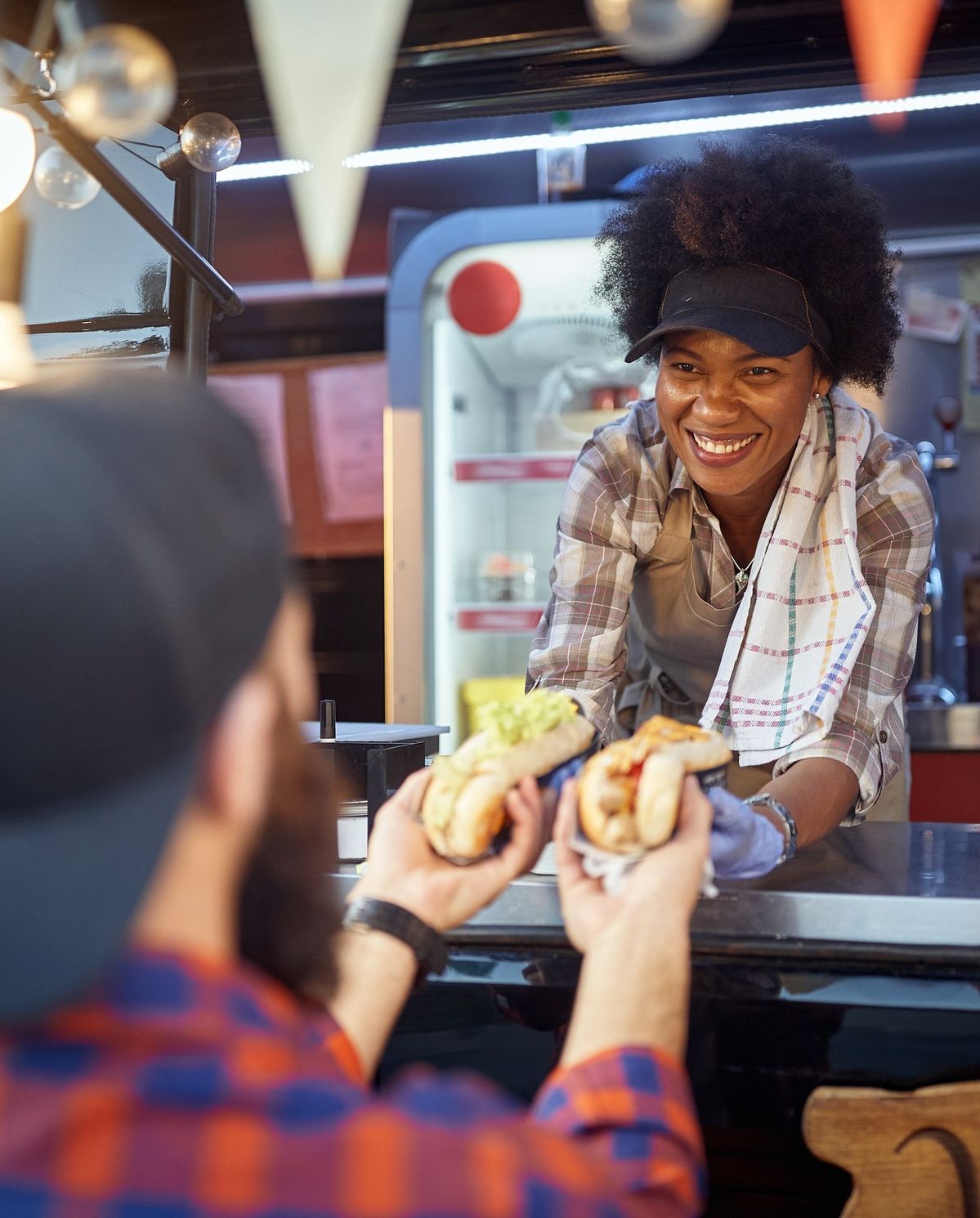 Food truck vendor serving customers at an event